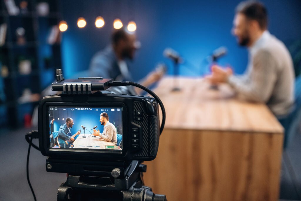 interviewing the musician. two radio presenters recording an audio broadcast in a studio