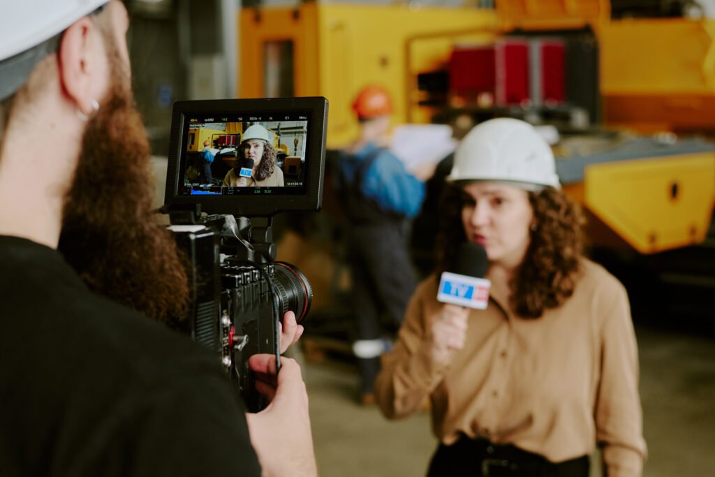 young caucasian woman journalist reporting news at industrial facility
